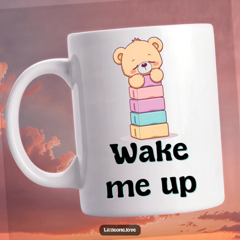 Funny mug showing a very sleepy teddy bear struggling to balance a tall, wobbly stack of colorful building blocks.