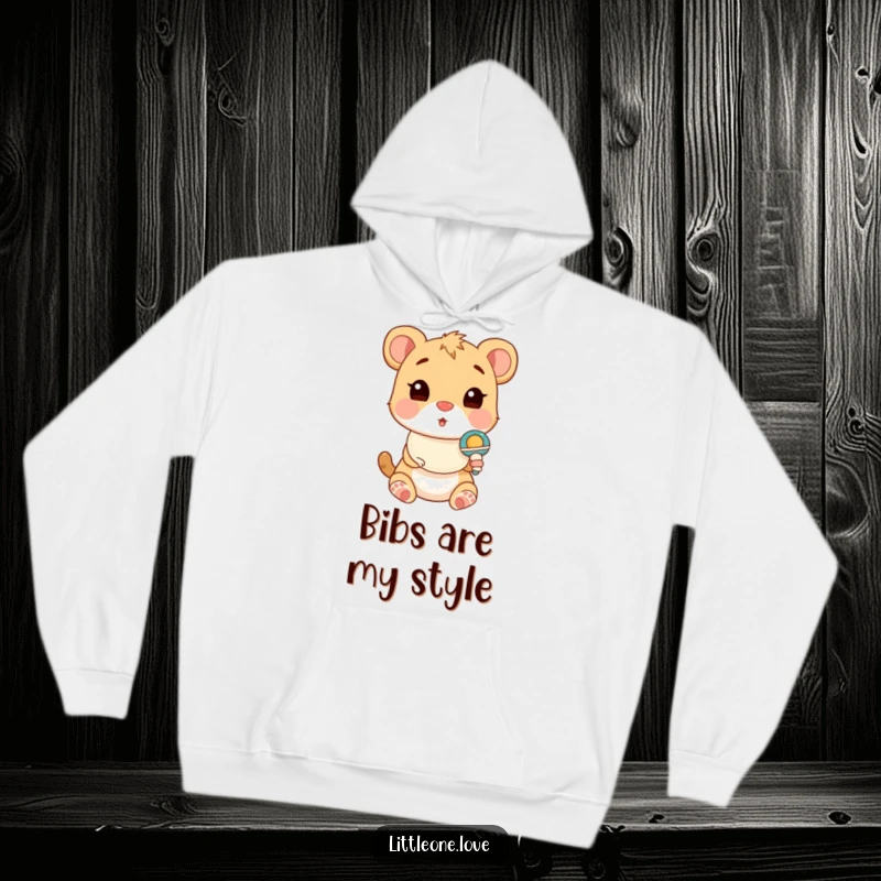 Funny Hoodie depicting a cute baby animal wearing a bib, looking comically surprised by a toy rattle, perfect for cozy days.